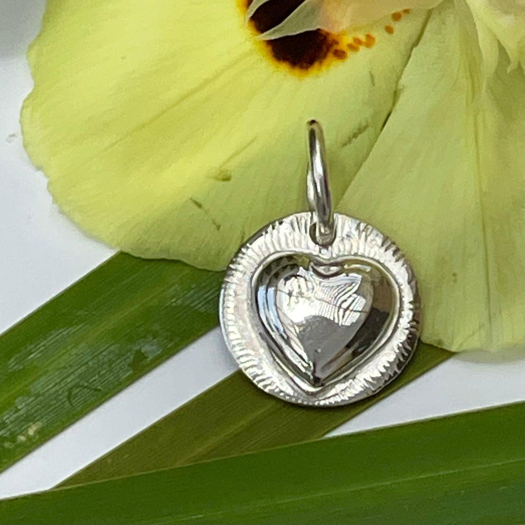 Heart Cremation Pendant.  The ash is secure within the Heart Sol Pod.  Thiis handmade sterling silver pendant is watersafe.