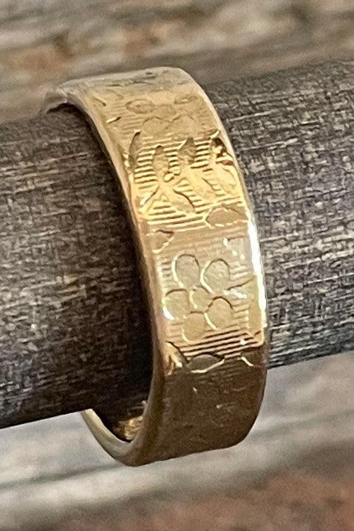 14k yellow gold cremation ring has ashes securely compressed within layers of gold.