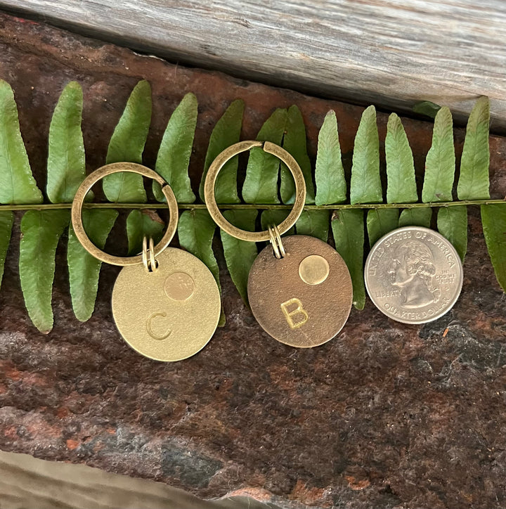 unique and handmade brass keychain and bag tags with cremation ash sealed inside.  Each piece is hand crafted.  The size and color of each piece is unique.