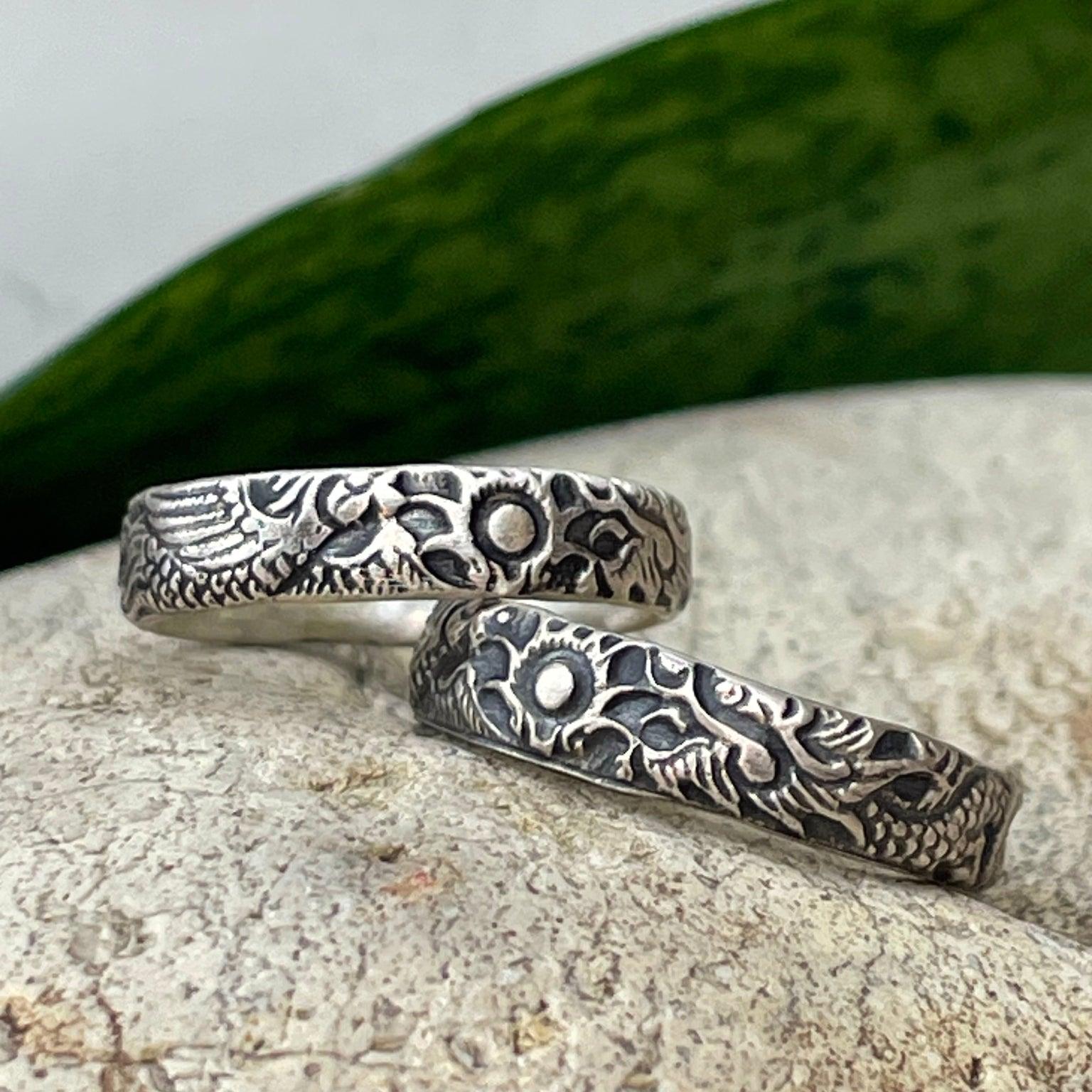 A dragon and a phoenix adorn this sterling silver ring