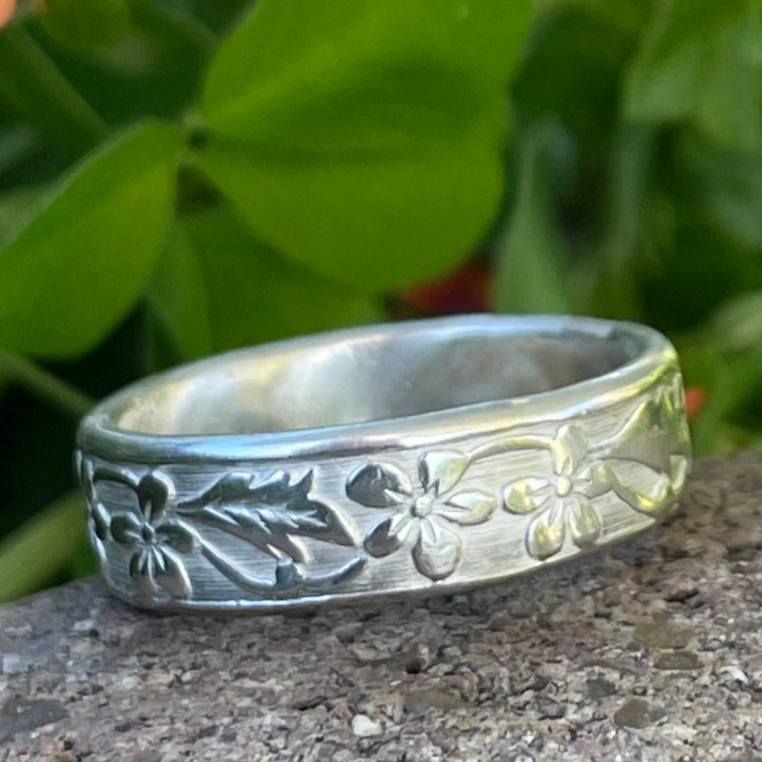 cremation ring with flower and leaf design.  This memorial ring is unique and hand made to order.  It is durable and can be worn in water.