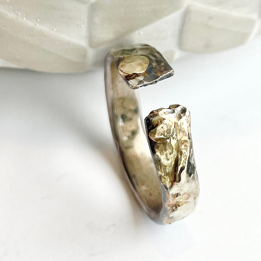 Sterling silver cremation ring with 14k yellow gold accents.   This is an open ring that will allow for some adjustability in size.   The gap is part of the style. Your ring will be sized with the gap.  